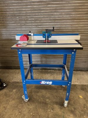 Used Kreg router table package including: router table with stand, casters, router lift, insert rings and flip stop for the fence
